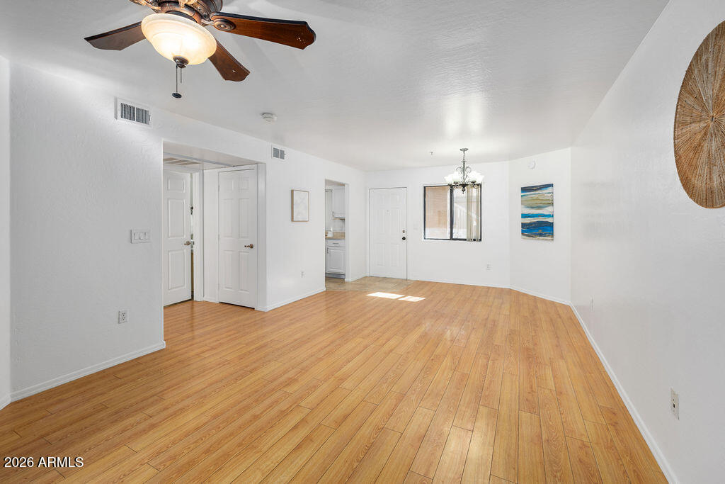 1287 North Alma School Road, Unit 123 Chandler, AZ 85224 - Photo 4 of 26 a view of empty room with wooden floor