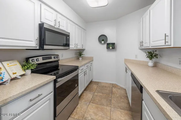 a kitchen with stainless steel appliances a stove microwave and refrigerator