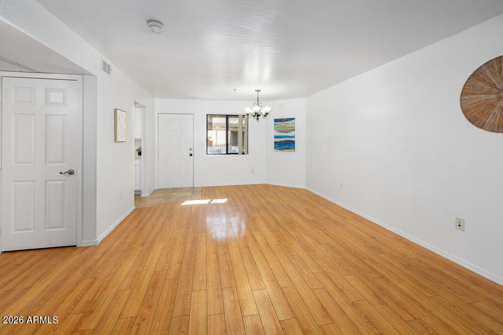 1287 North Alma School Road, Unit 123 Chandler, AZ 85224 - Photo 9 of 26 wooden floor in an empty room with a window