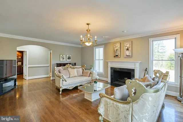 a living room with furniture and a chandelier