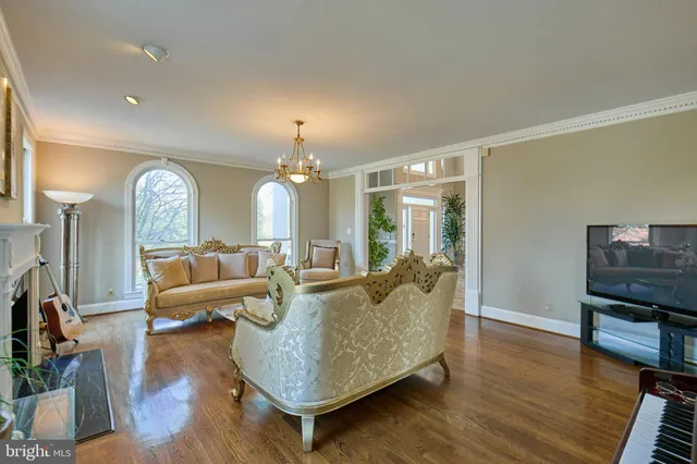 a living room with furniture fireplace and wooden floor