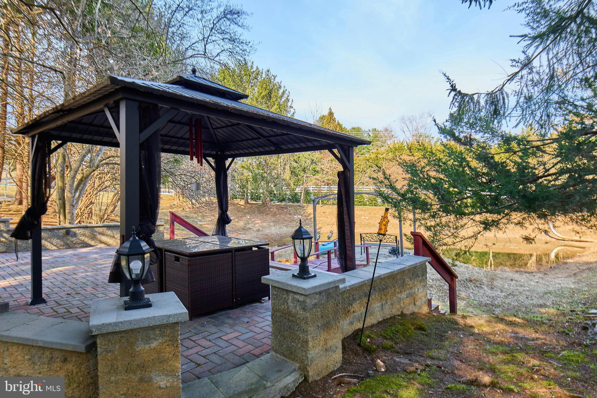 6830 Clifton Road Clifton, VA 20124 - Photo 68 of 85 Covered outdoor seating by the pond