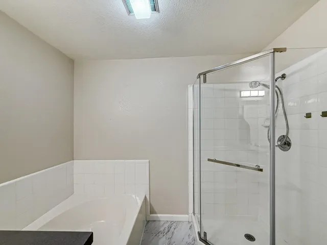 a bathroom with a bathtub and a shower