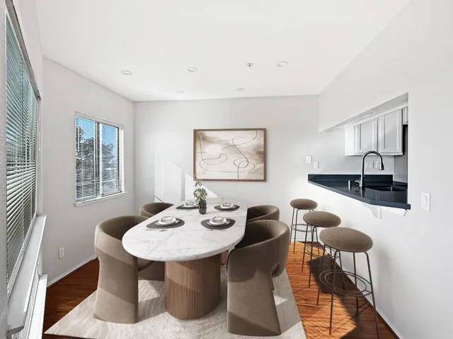 a view of a dining room with furniture and window