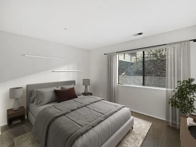 a bedroom with a bed and a window