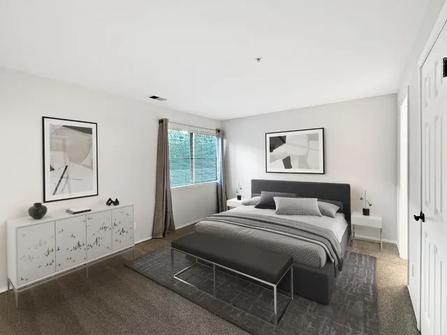 a bedroom with a bed and a window