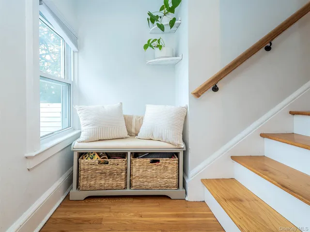 a view of entryway with wooden floor and front door