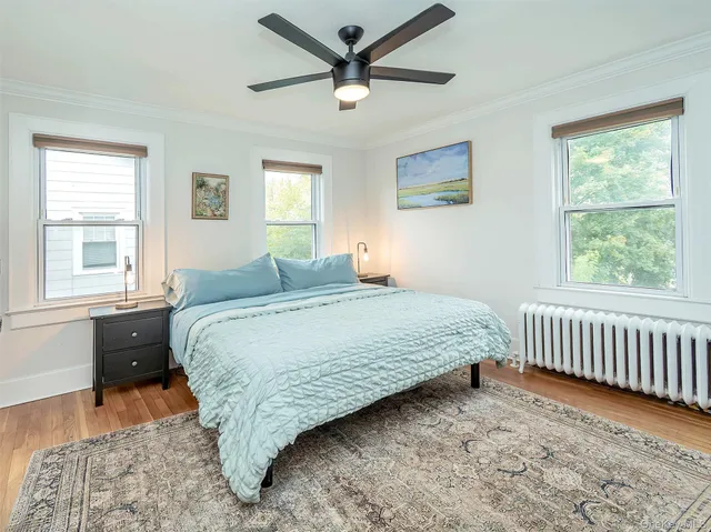 a bedroom with a bed and a window