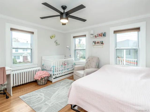 a bedroom with two beds and a window