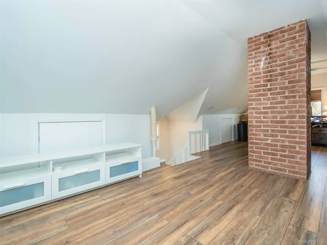 a view of empty room with wooden floor and cabinet