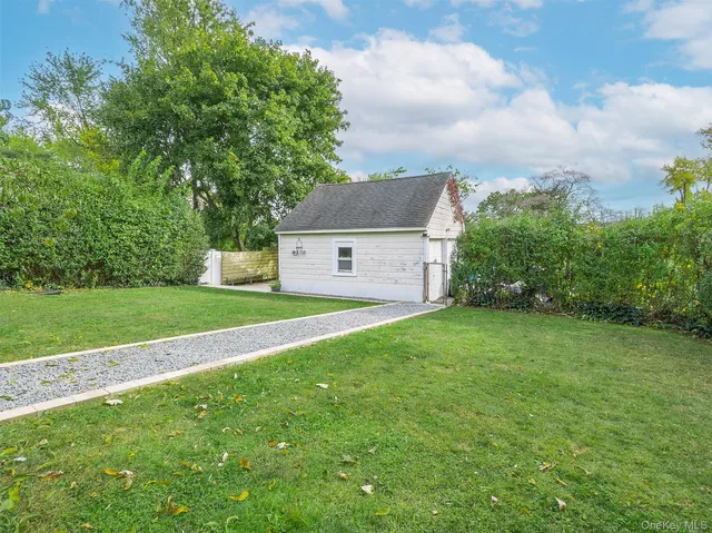 a aerial view of a house with a yard and large trees