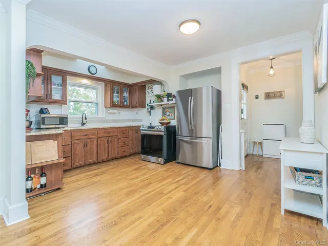 a kitchen with stainless steel appliances a refrigerator sink and cabinets
