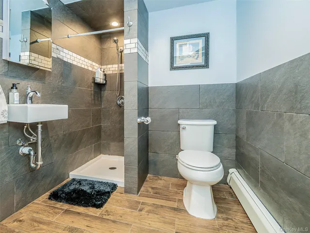 a bathroom with a sink toilet and a shower