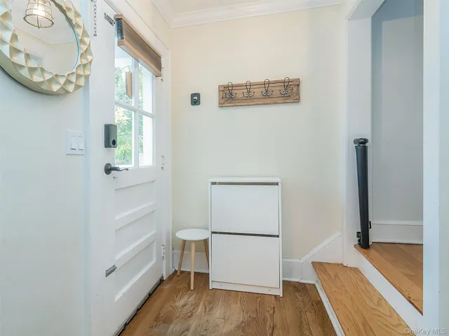 a view of a hallway to rooms and wooden floor