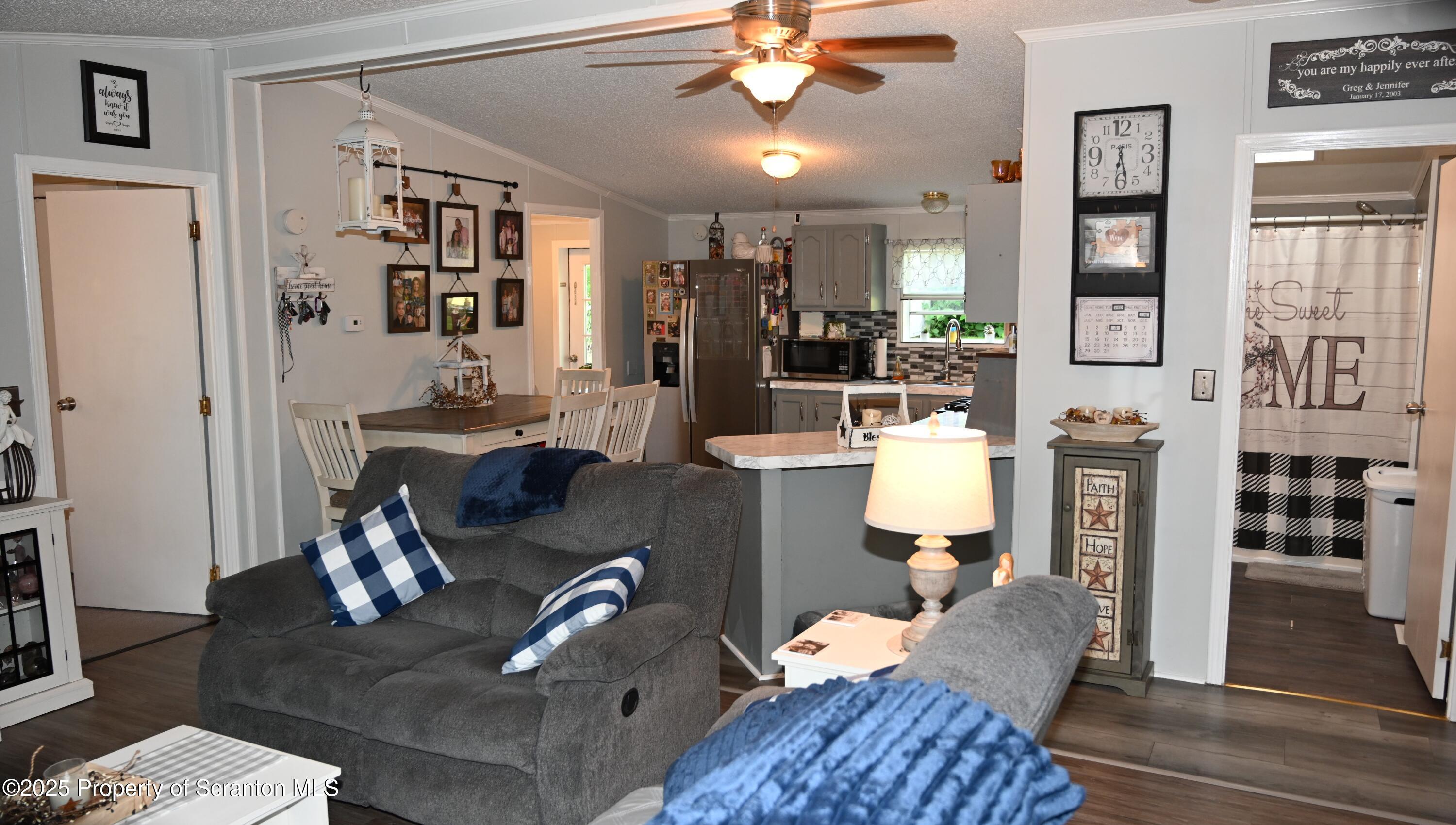 68 Spring Street Great Bend, PA 18821 - Photo 2 of 32 a living room with furniture a flat screen tv and a fireplace