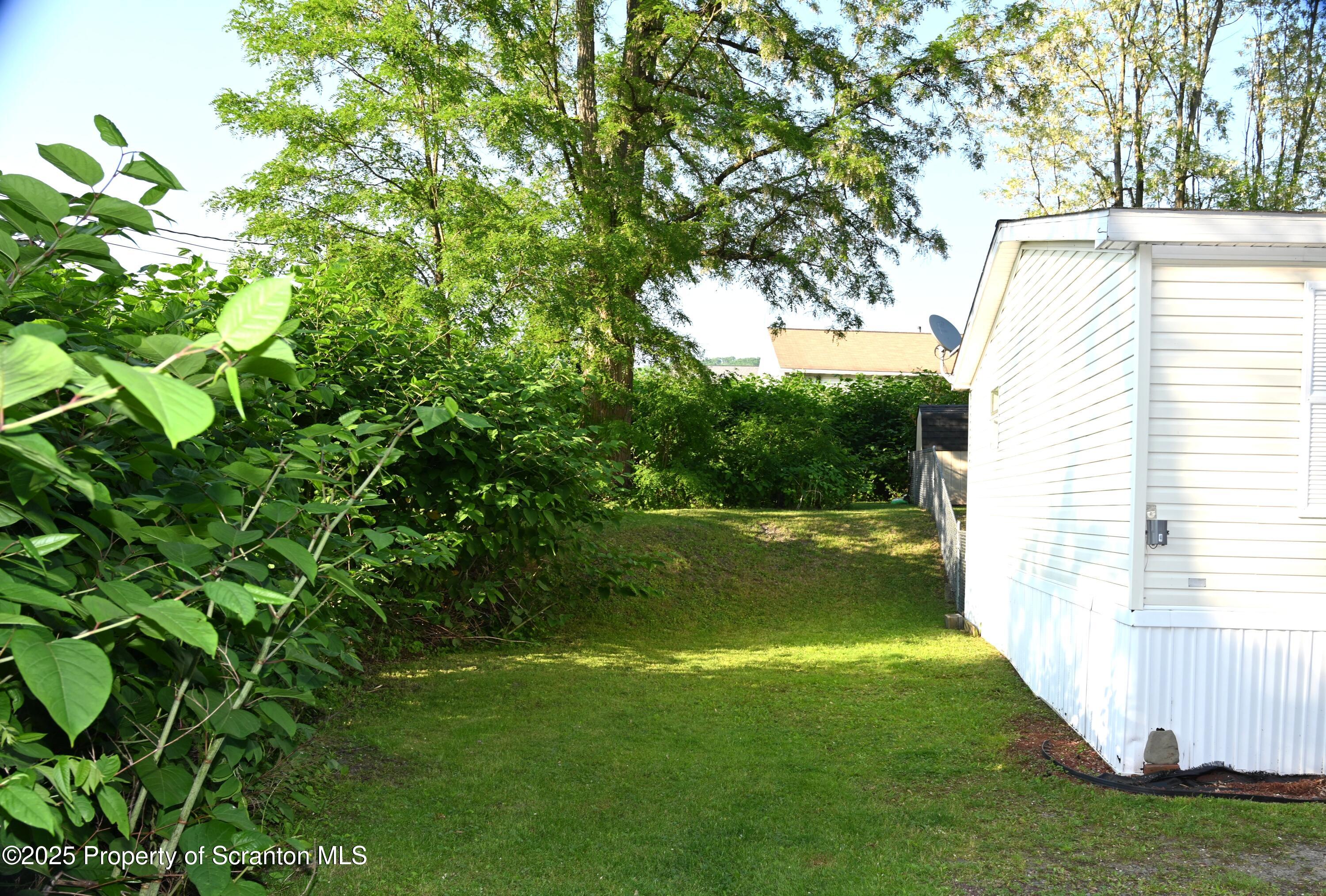 68 Spring Street Great Bend, PA 18821 - Photo 21 of 32 a view of a backyard with a garden