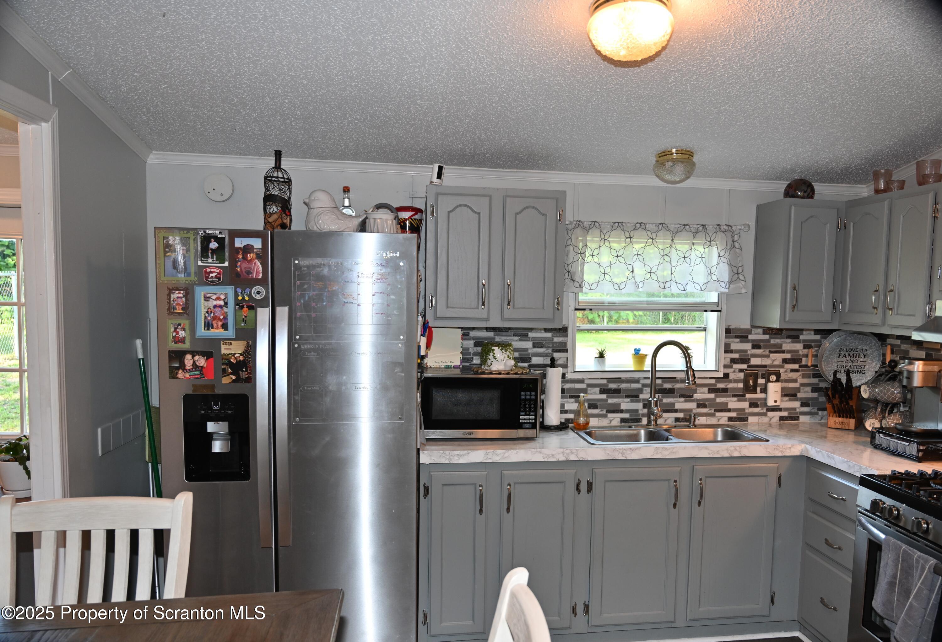 68 Spring Street Great Bend, PA 18821 - Photo 4 of 32 a kitchen with refrigerator and window