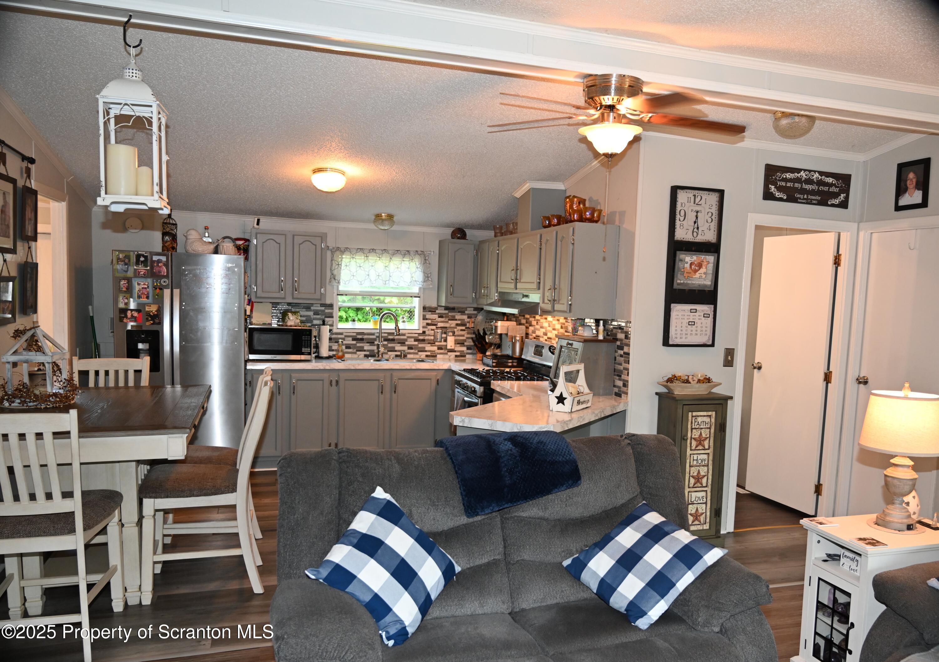 68 Spring Street Great Bend, PA 18821 - Photo 8 of 32 a kitchen with stainless steel appliances kitchen island granite countertop a refrigerator and microwave