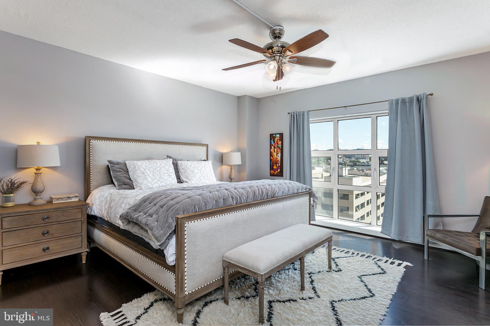 250 President Street, Unit 605 Baltimore, MD 21202 - Photo 9 of 38 a bedroom with a large bed and a window