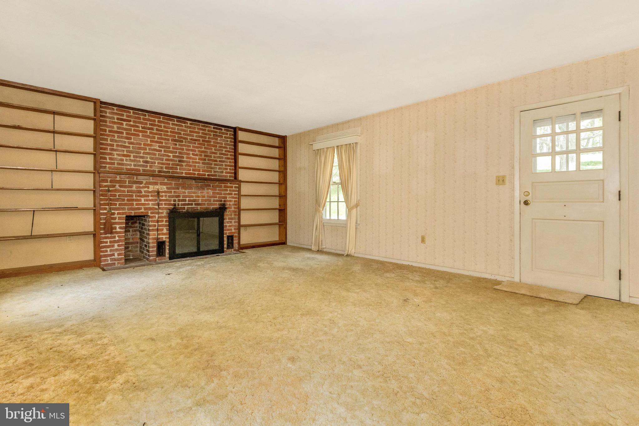 6938 Bowers Road Frederick, MD 21702 - Photo 29 of 40 an empty room with fireplace and cabinet