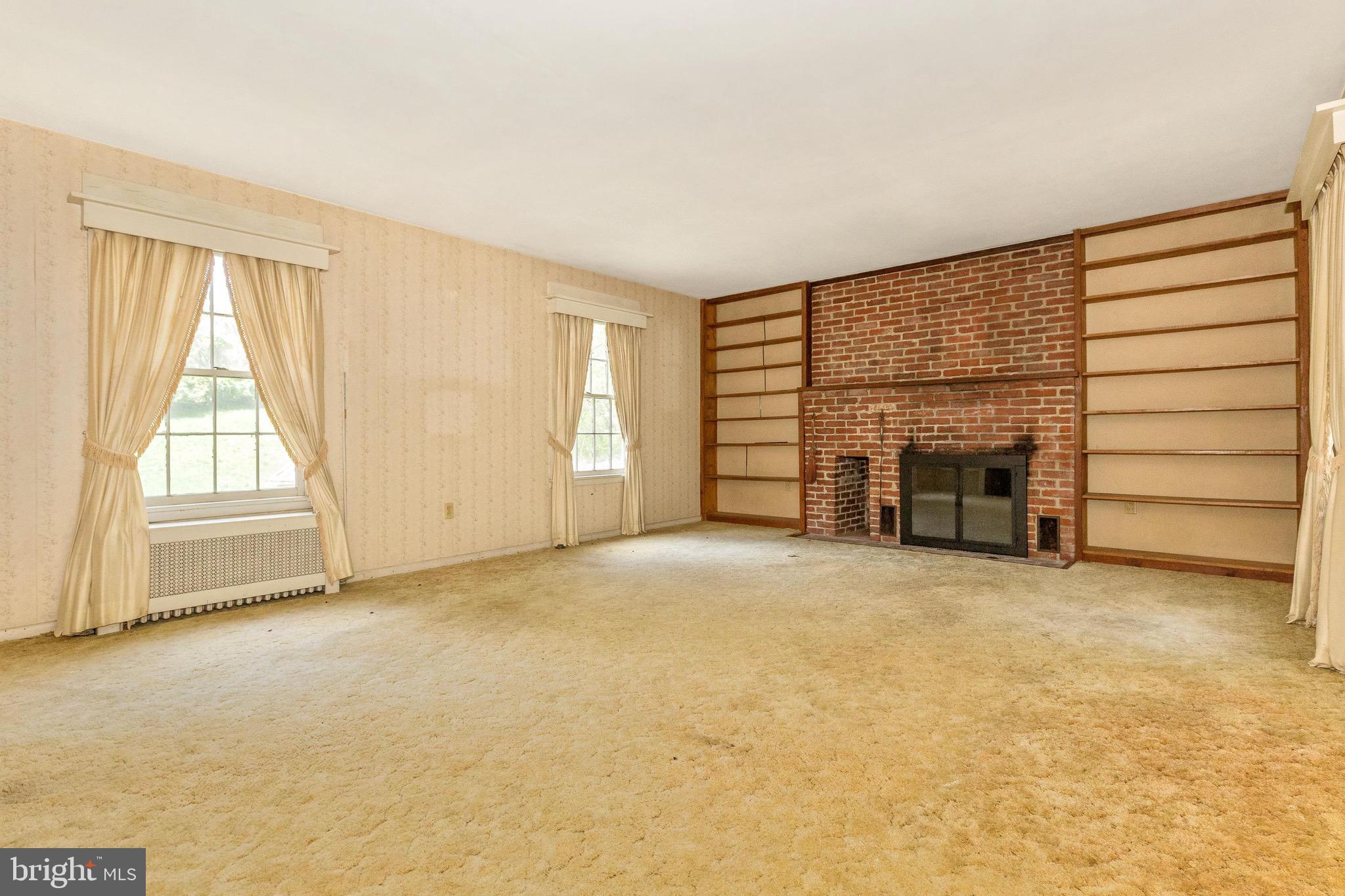6938 Bowers Road Frederick, MD 21702 - Photo 30 of 40 an empty room with furniture and a fireplace