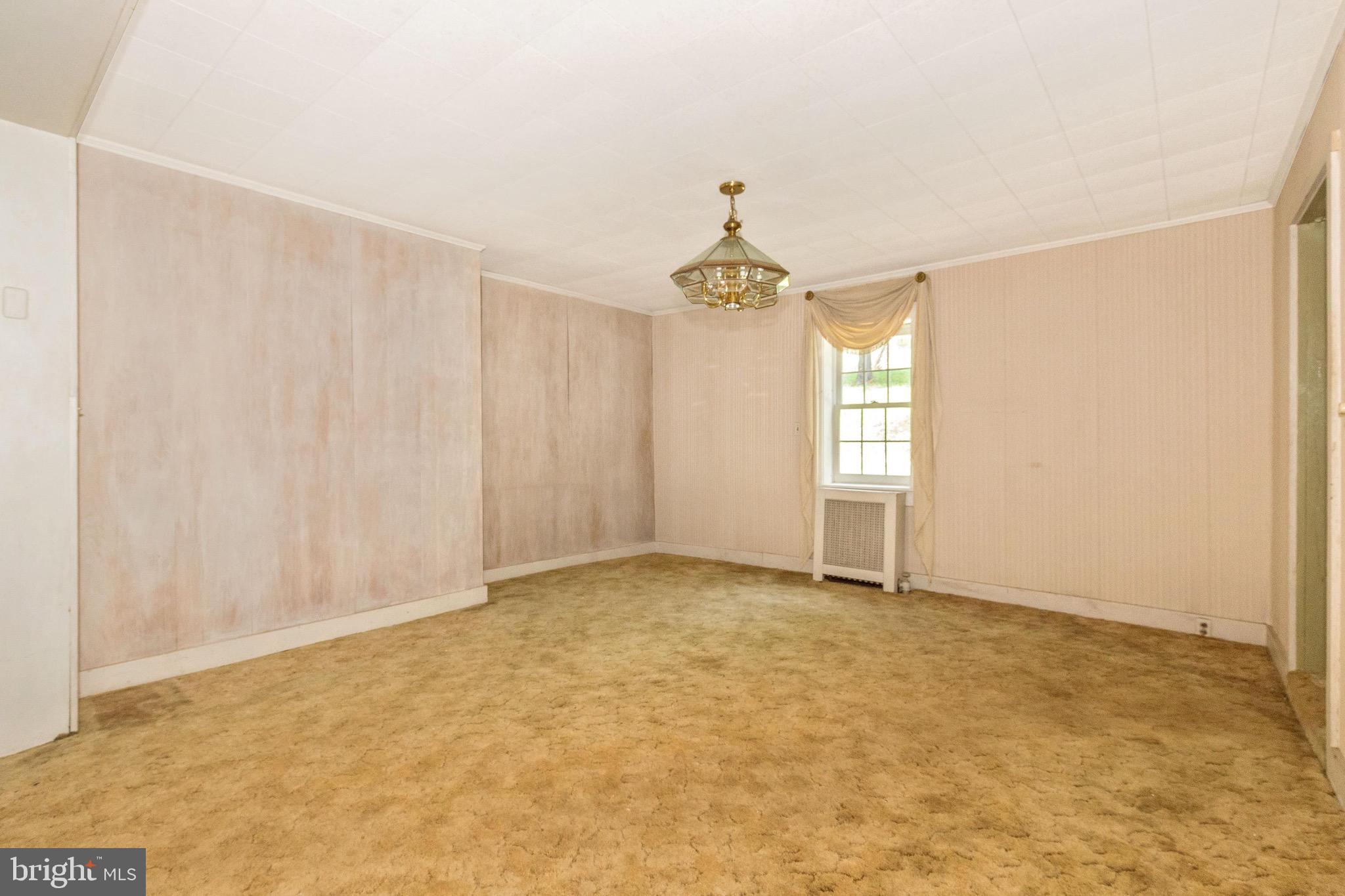 6938 Bowers Road Frederick, MD 21702 - Photo 32 of 40 an empty room with windows and chandelier fan