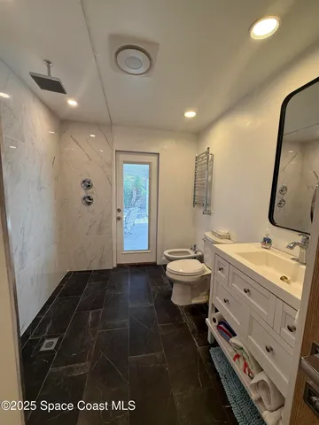 a bedroom with a bed window and a chair