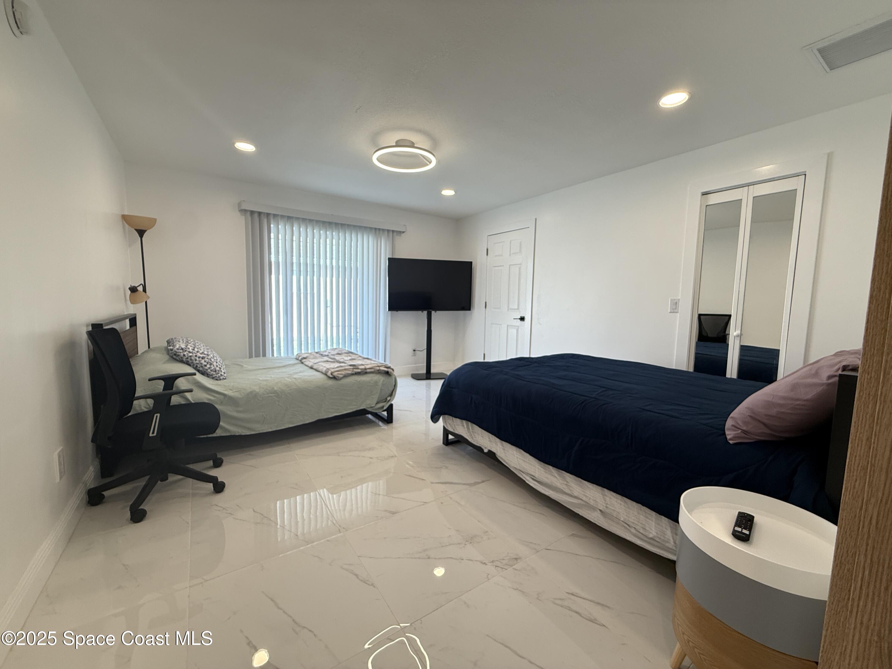 306 School Road Indian Harbour Beach, FL 32937 - Photo 13 of 21 a bedroom with a bed and a couch