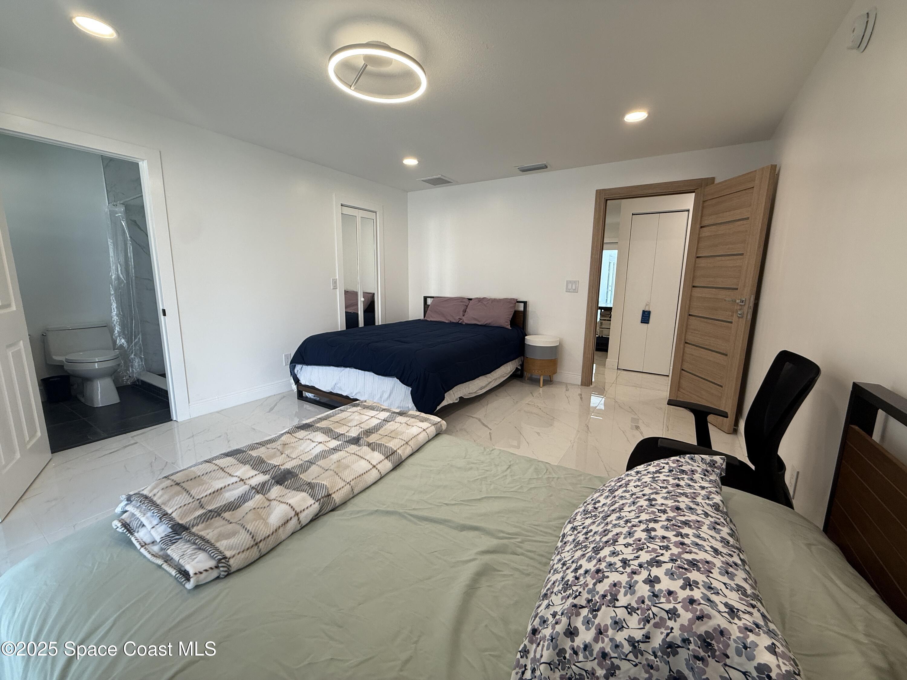 306 School Road Indian Harbour Beach, FL 32937 - Photo 14 of 21 a bedroom with a bed window and a chair