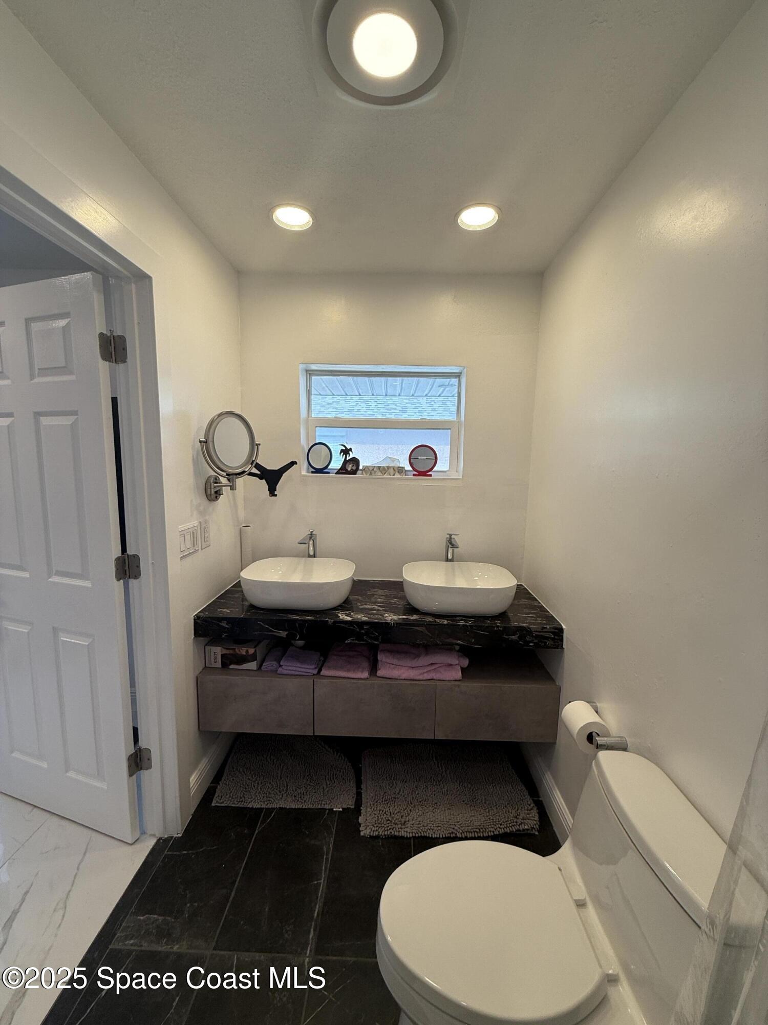 306 School Road Indian Harbour Beach, FL 32937 - Photo 15 of 21 a bathroom with a sink toilet and shower