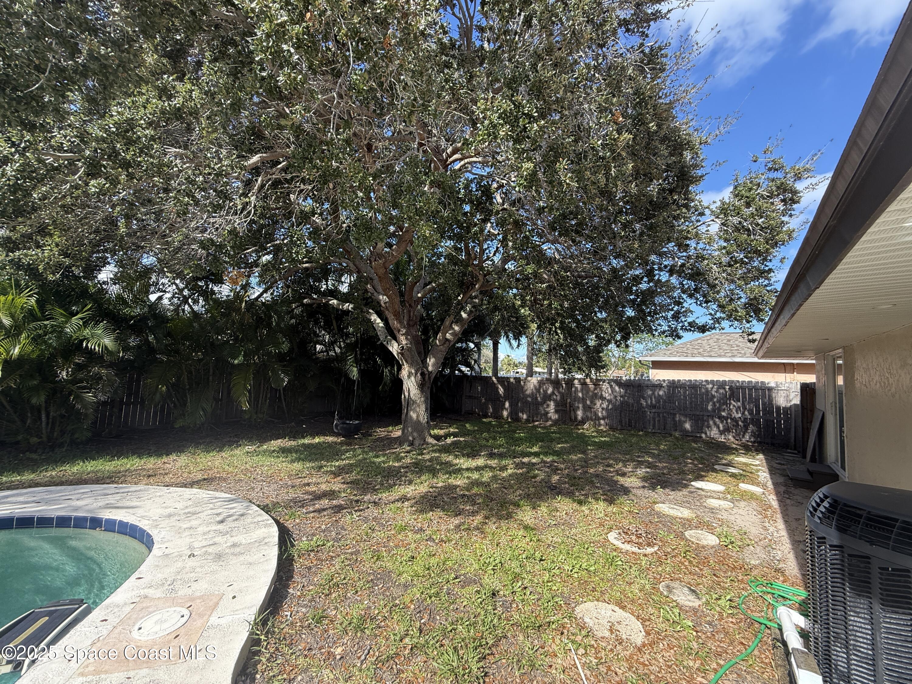 306 School Road Indian Harbour Beach, FL 32937 - Photo 17 of 21 a view of swimming pool with a backyard