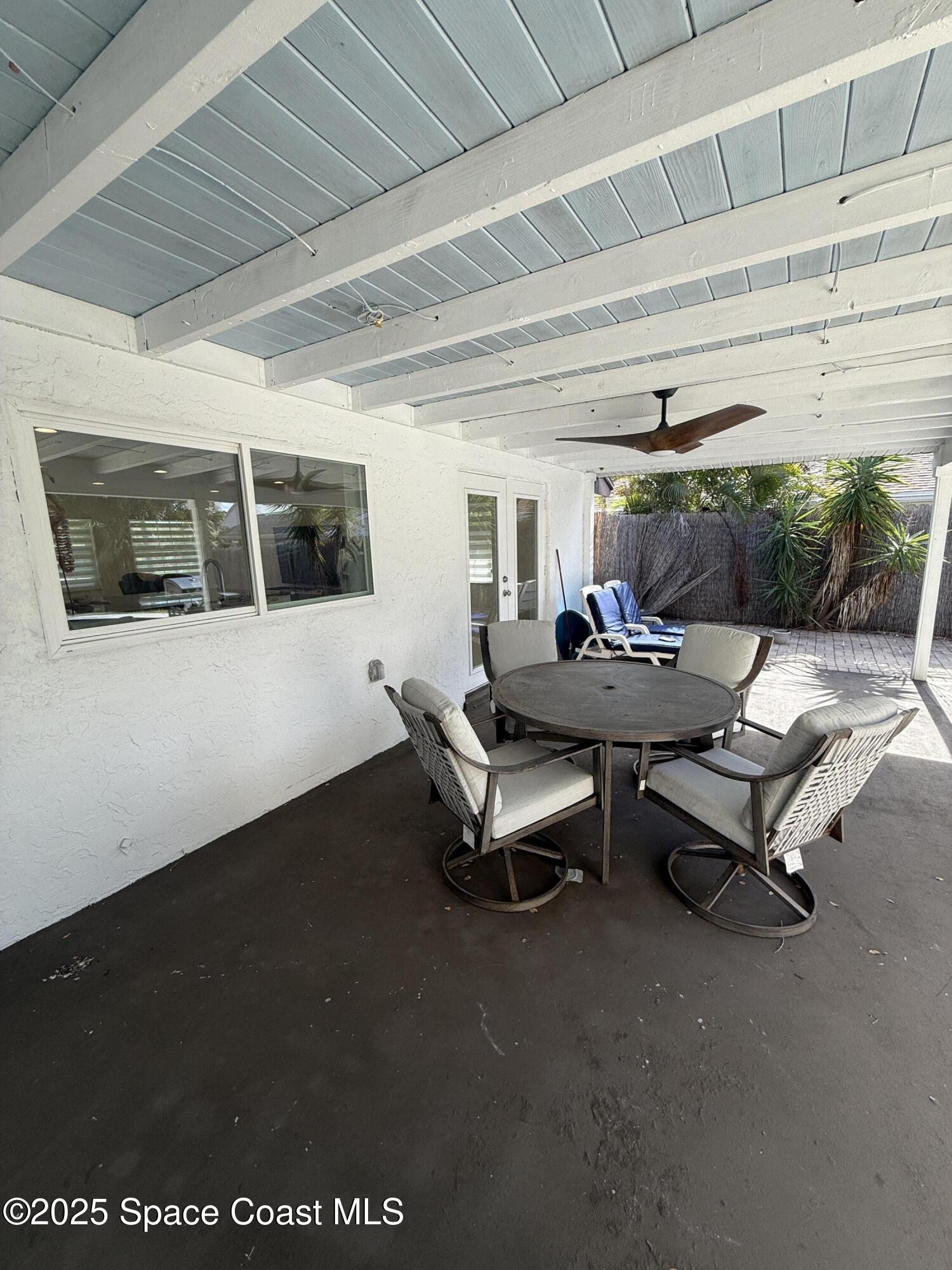 306 School Road Indian Harbour Beach, FL 32937 - Photo 19 of 21 a living room with furniture a flat screen tv and a table