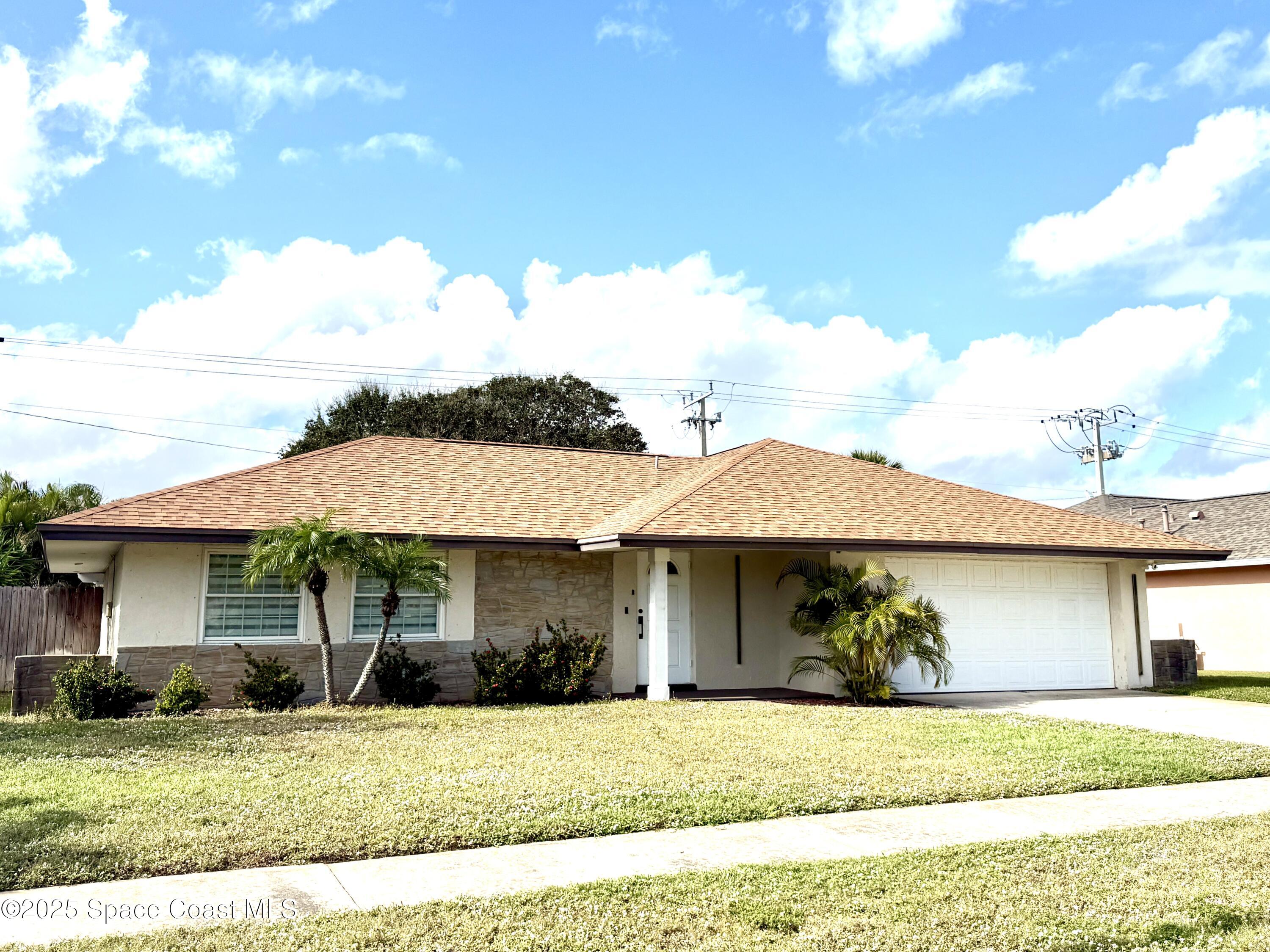 306 School Road Indian Harbour Beach, FL 32937 - Photo 2 of 21 a front view of a house with garden