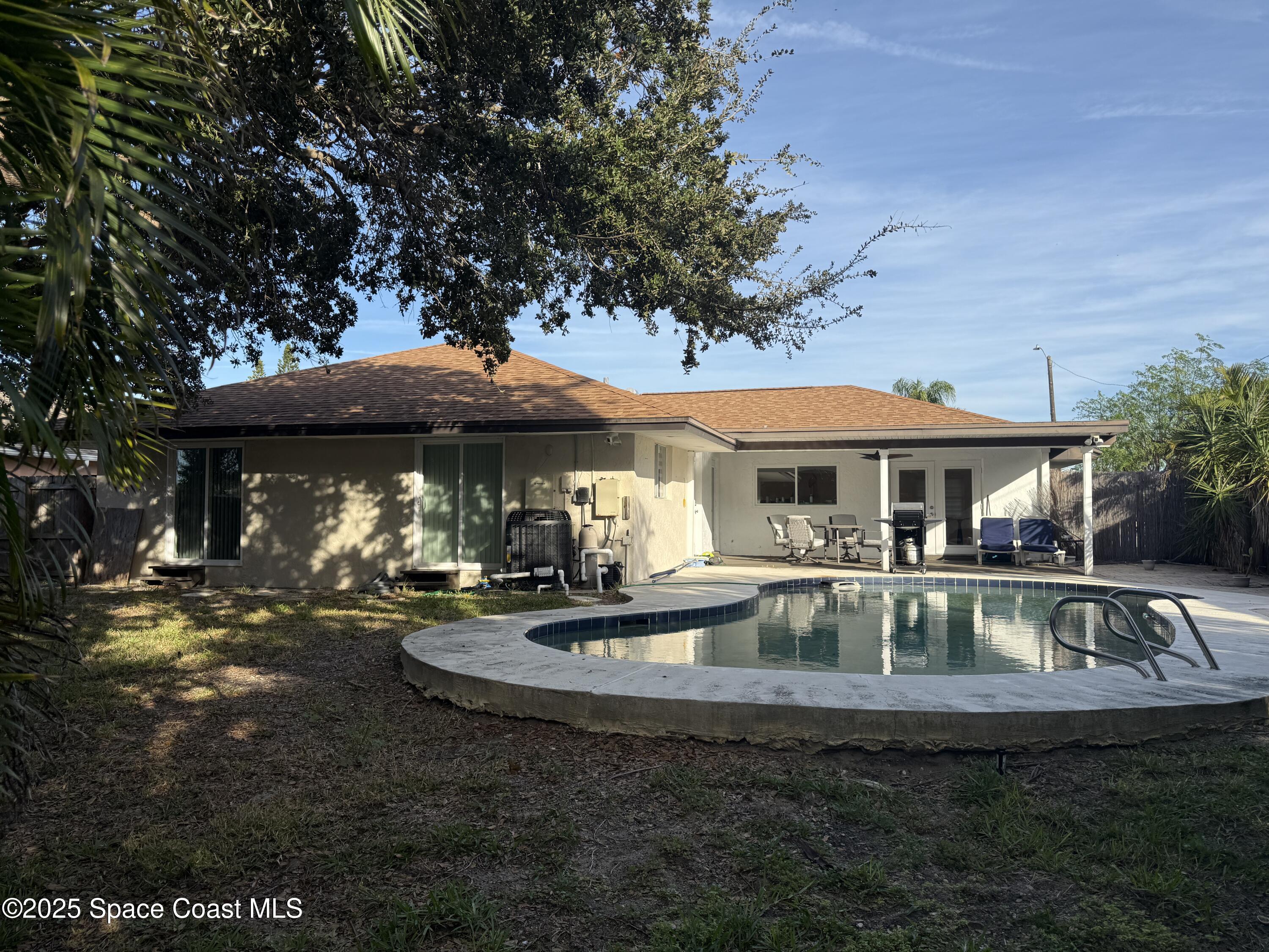 306 School Road Indian Harbour Beach, FL 32937 - Photo 21 of 21 a view of a house with swimming pool and sitting area