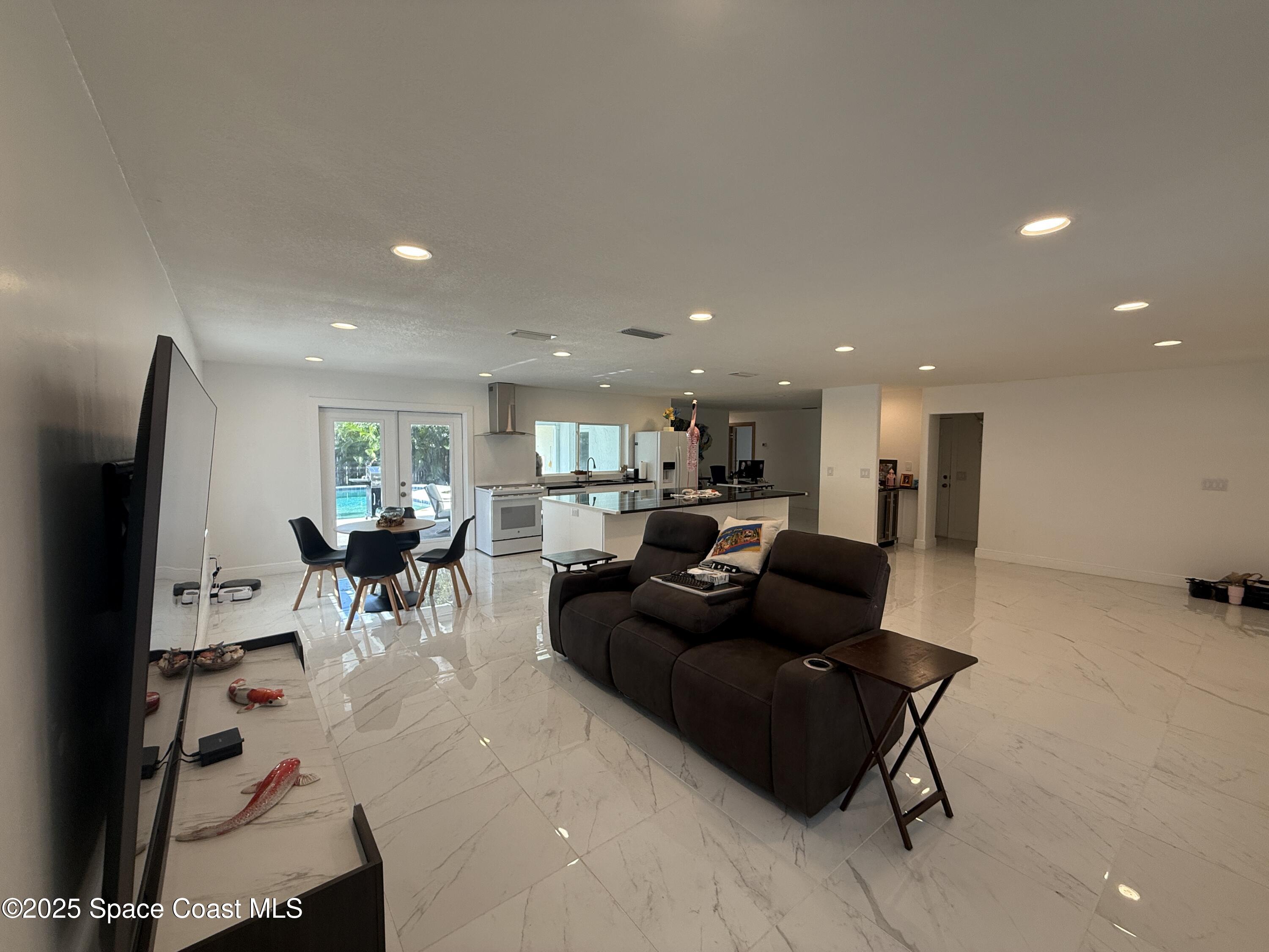 306 School Road Indian Harbour Beach, FL 32937 - Photo 4 of 21 a living room with furniture and a flat screen tv