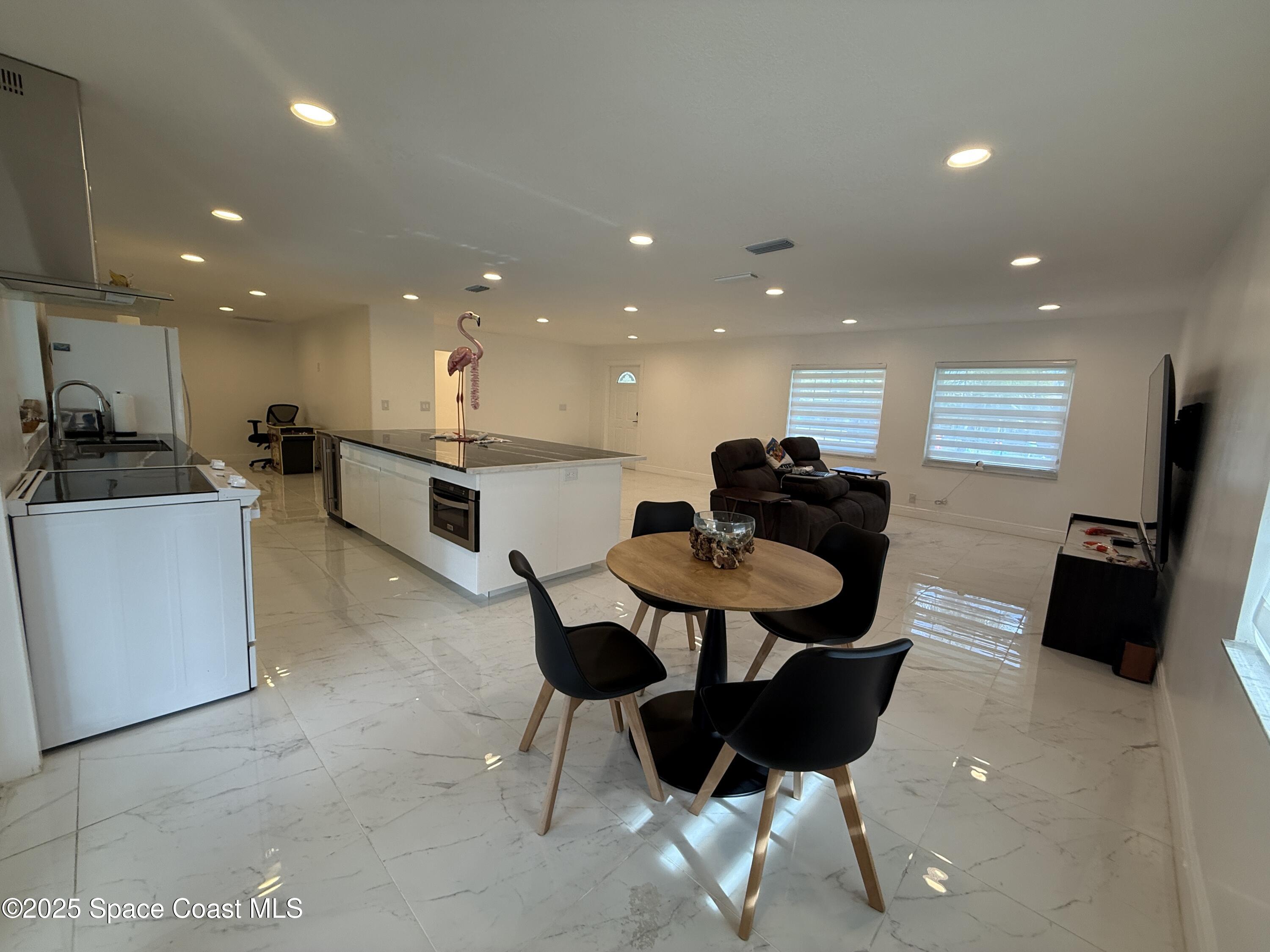 306 School Road Indian Harbour Beach, FL 32937 - Photo 5 of 21 a living room with furniture and a chandelier
