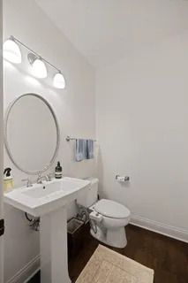 a bathroom with a granite countertop sink a toilet and shower