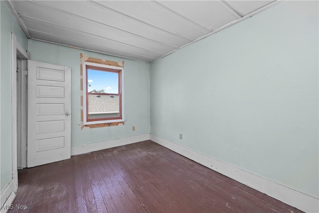 6927 North Wildacre Road Curtice, OH 43412 - Photo 29 of 44 Unfurnished room featuring dark wood-style floors and baseboards