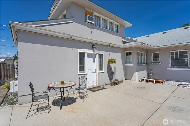 a building outdoor space with patio furniture and potted plants