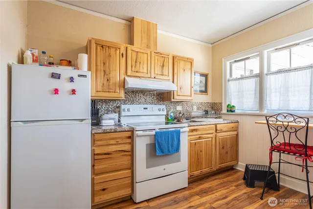 a kitchen with stainless steel appliances a refrigerator sink and white cabinets