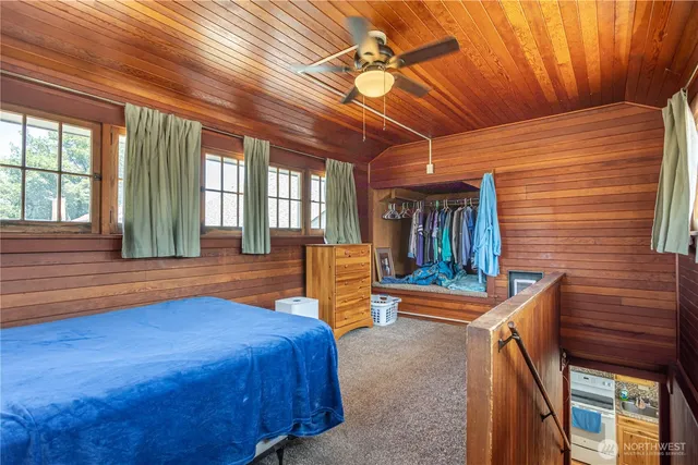 a bedroom with furniture and large window