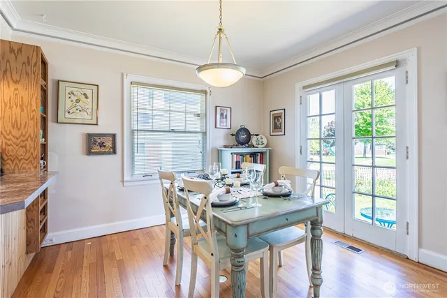 a view of a dining room with furniture window and wooden floor