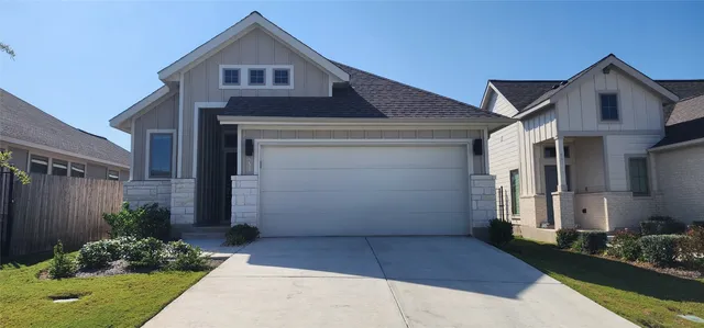 a front view of house with a garden