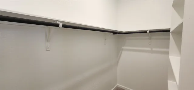 a white toilet sitting next to a shower