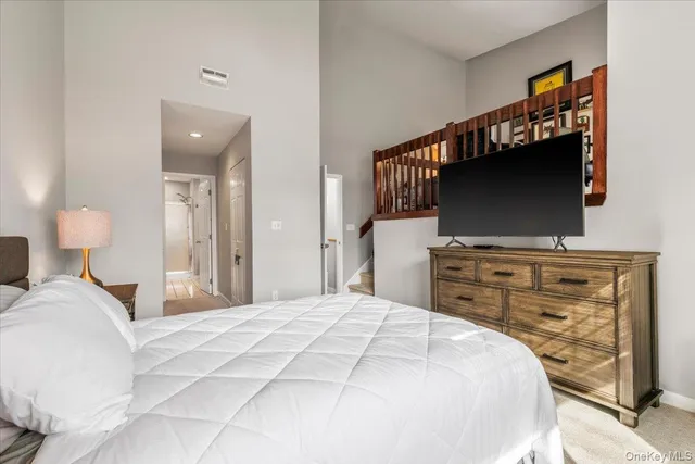 a bedroom with a flat screen tv and a bed