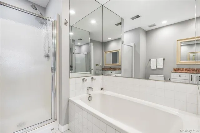 a large spacious bathroom with a large tub shower and sink