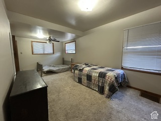 481 East Center Street Logan, UT 84321 - Photo 12 of 23 Carpeted room with a ceiling-mounted light fixture, ceiling fan, and two windows with blinds