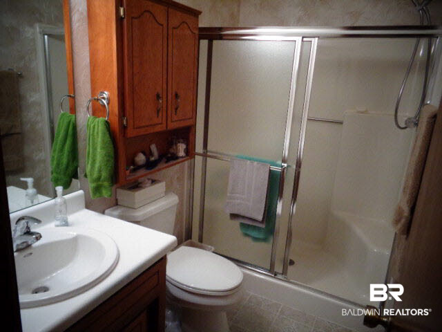 2804 Pine Ridge Drive Lillian, AL 36549 - Photo 29 of 39 Single vanity. Walk-in shower with 2 benches and sliding doors. Vinyl floor. Squirrel Cage fans with 4 switches, lights above sink and overhead, fan and night light.