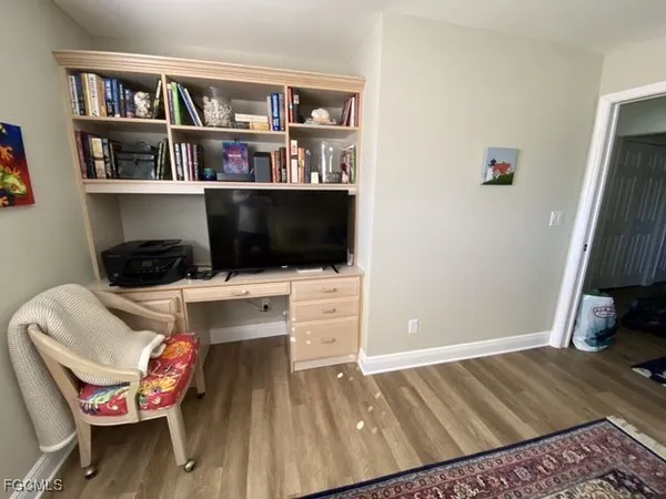 a bedroom with a bed and a bookshelf