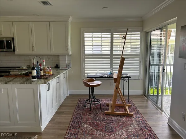 a kitchen with sink a window and cabinets